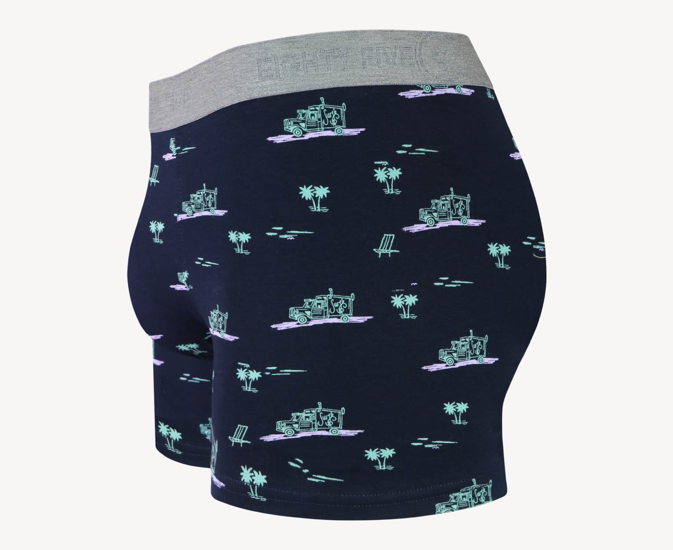 Side view of men’s 95% cotton boxer brief in black with pink surf truck and green palms print, contoured pouch, and tailored leg cut