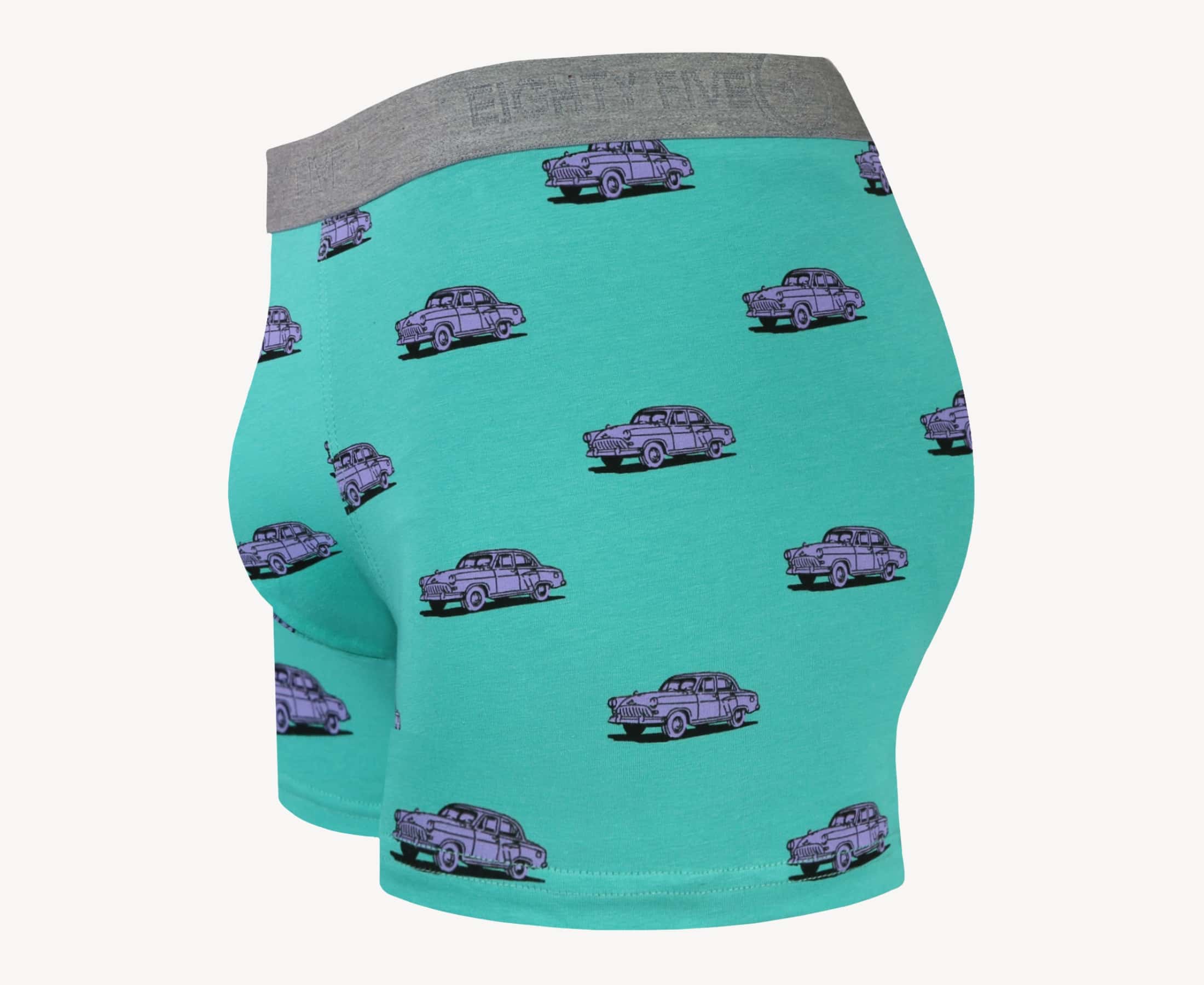 Side view of men’s 95% cotton boxer brief in turquoise with pink vintage car print, contoured pouch, and tailored leg cut