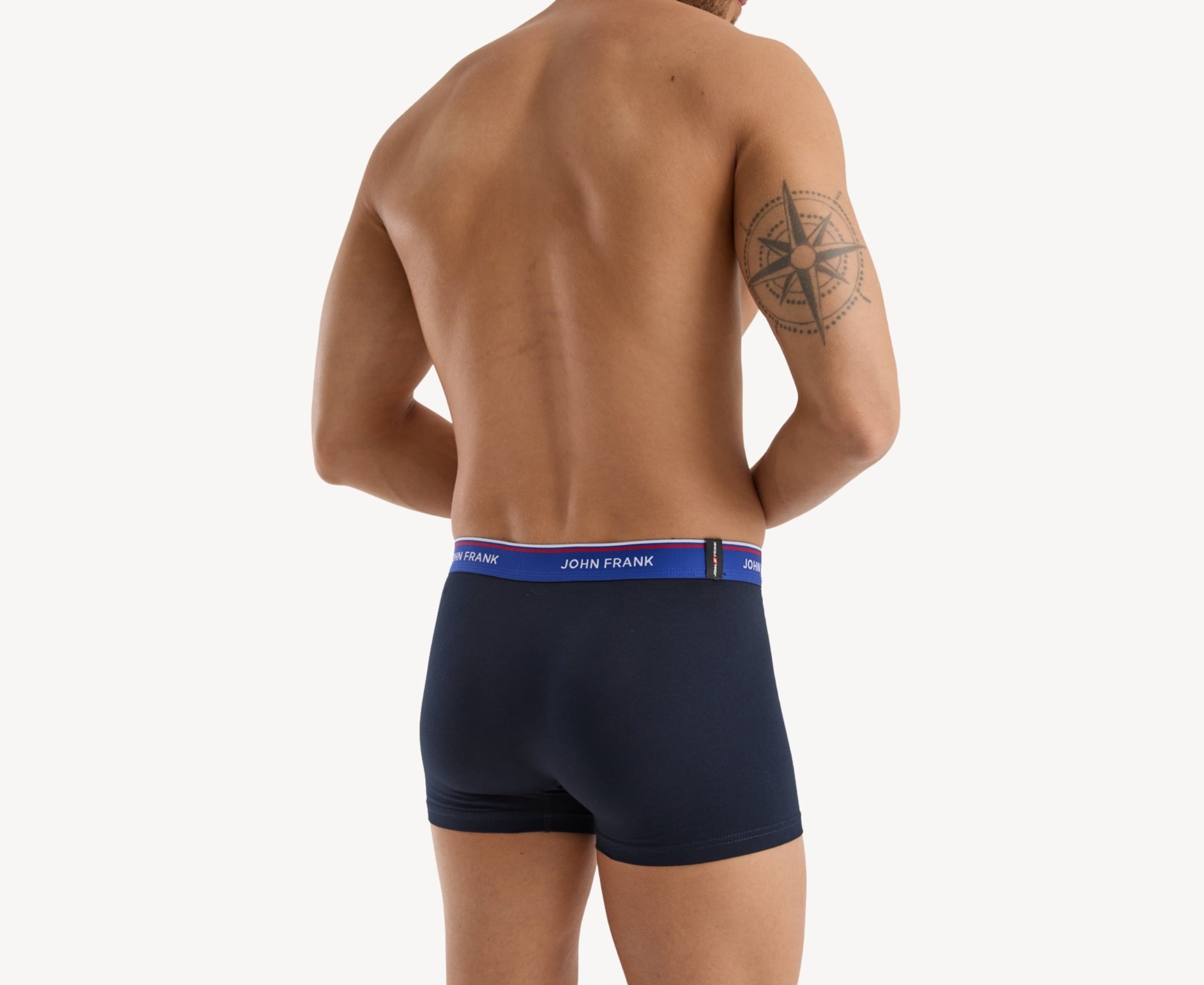 Back view of model wearing men’s 95% cotton boxer brief in midnight blue with indigo striped waistband and rear detail