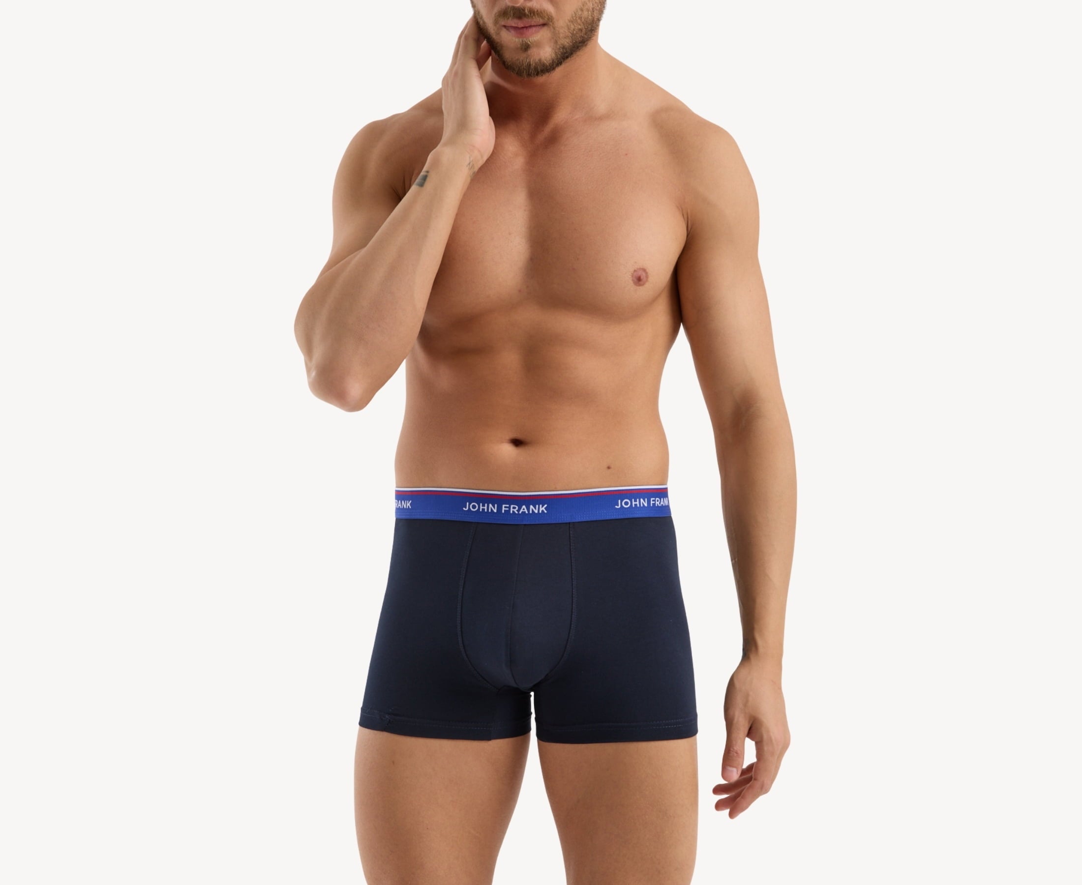Front view of model wearing men’s 95% cotton boxer brief in midnight blue with indigo striped waistband and soft stretch
