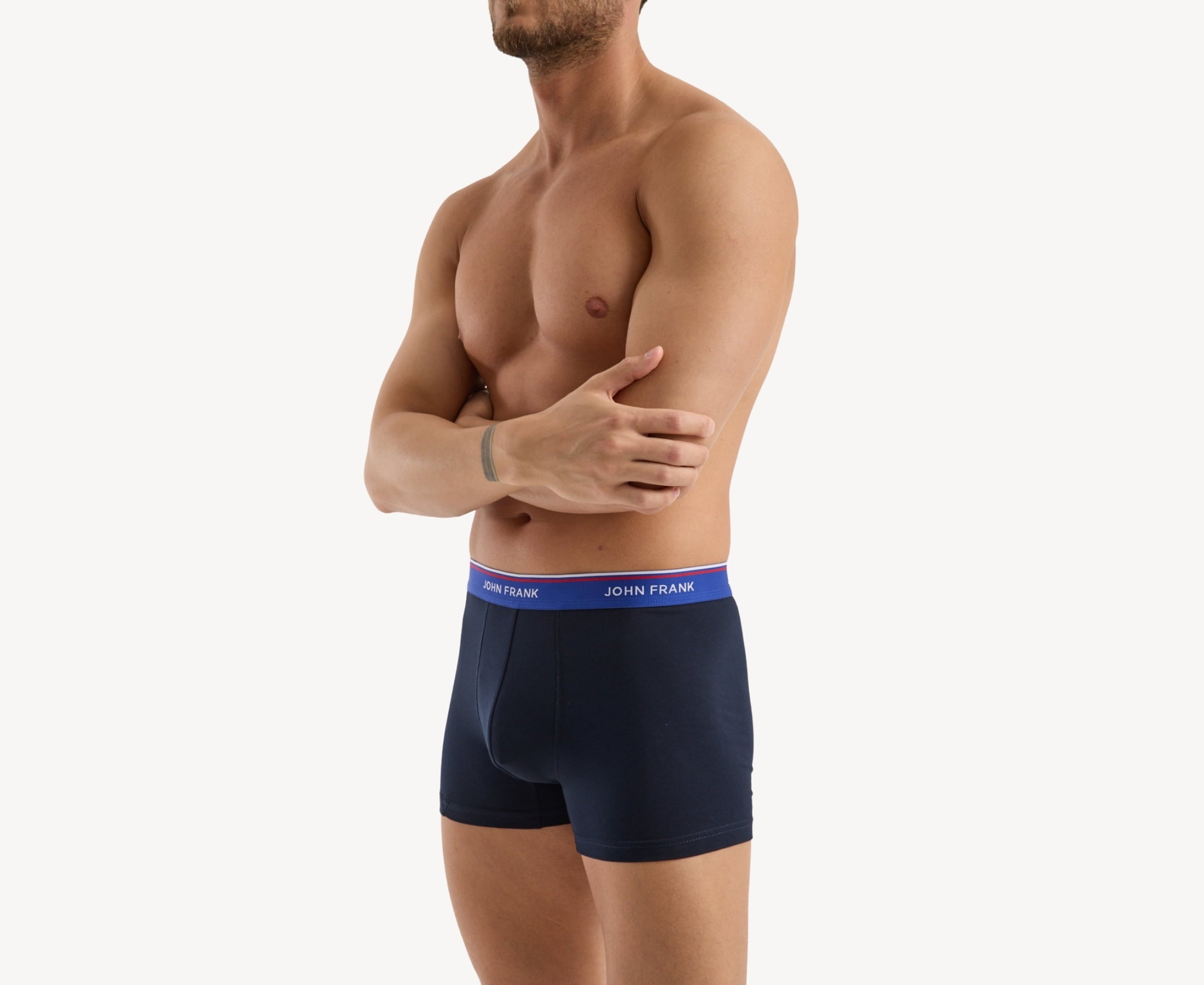 Side view of model wearing men’s 95% cotton boxer brief in midnight blue with indigo striped waistband, contoured pouch, and tailored leg cut