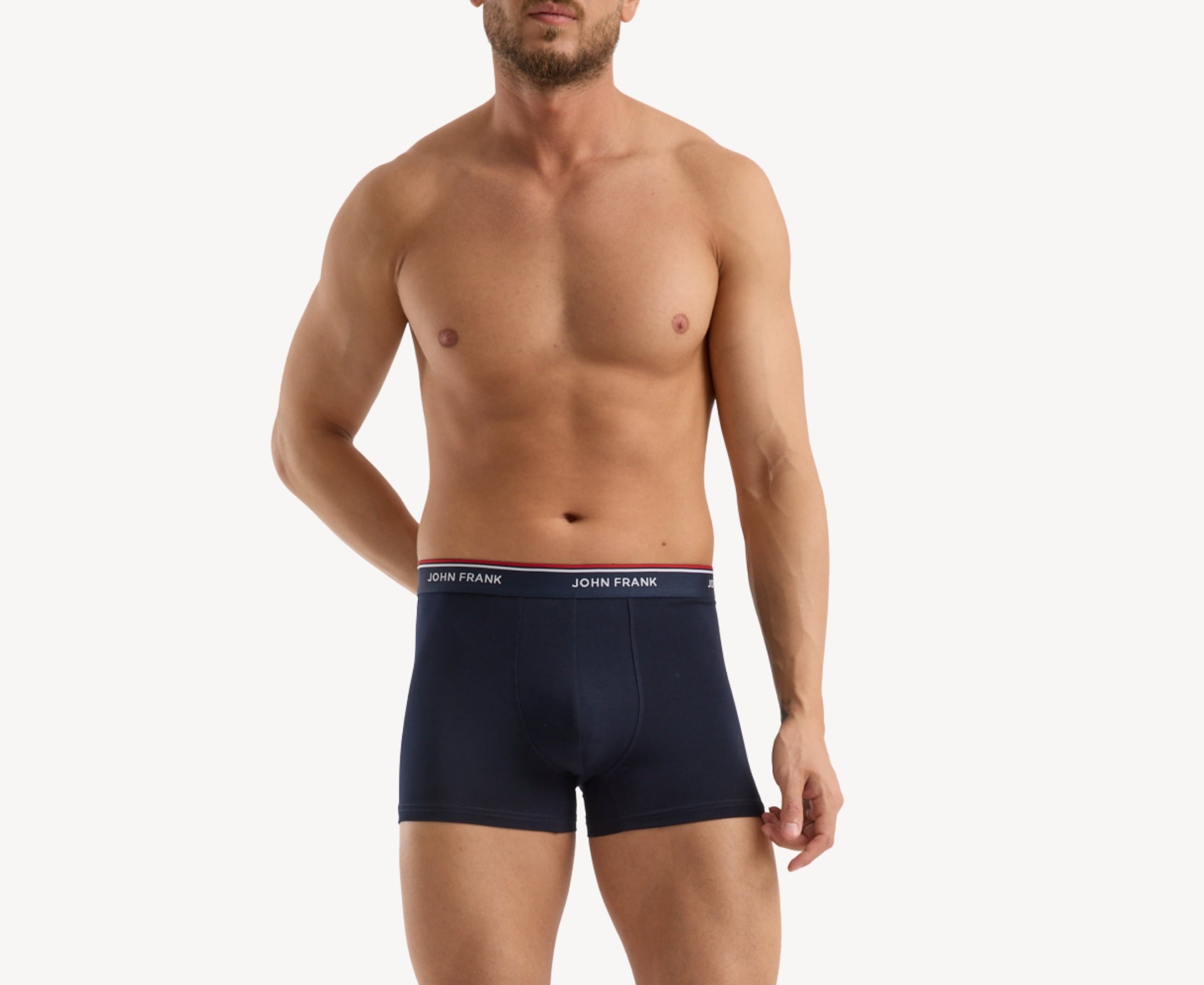 Front view of model wearing men’s 95% cotton boxer brief in midnight blue with midnight blue striped waistband and soft stretch