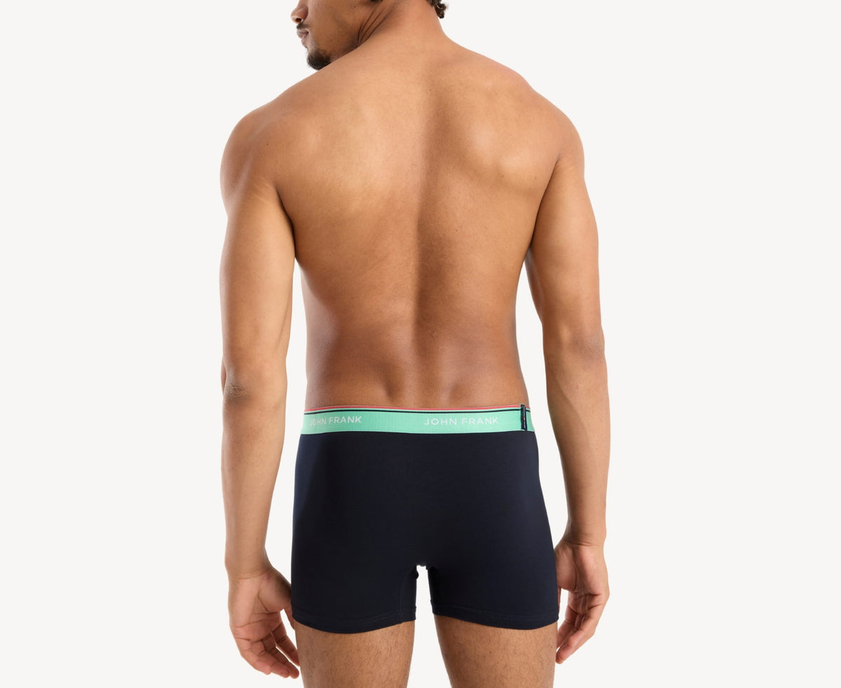 Back view of model wearing men’s 95% cotton boxer brief in midnight blue with sea green striped waistband and rear detail