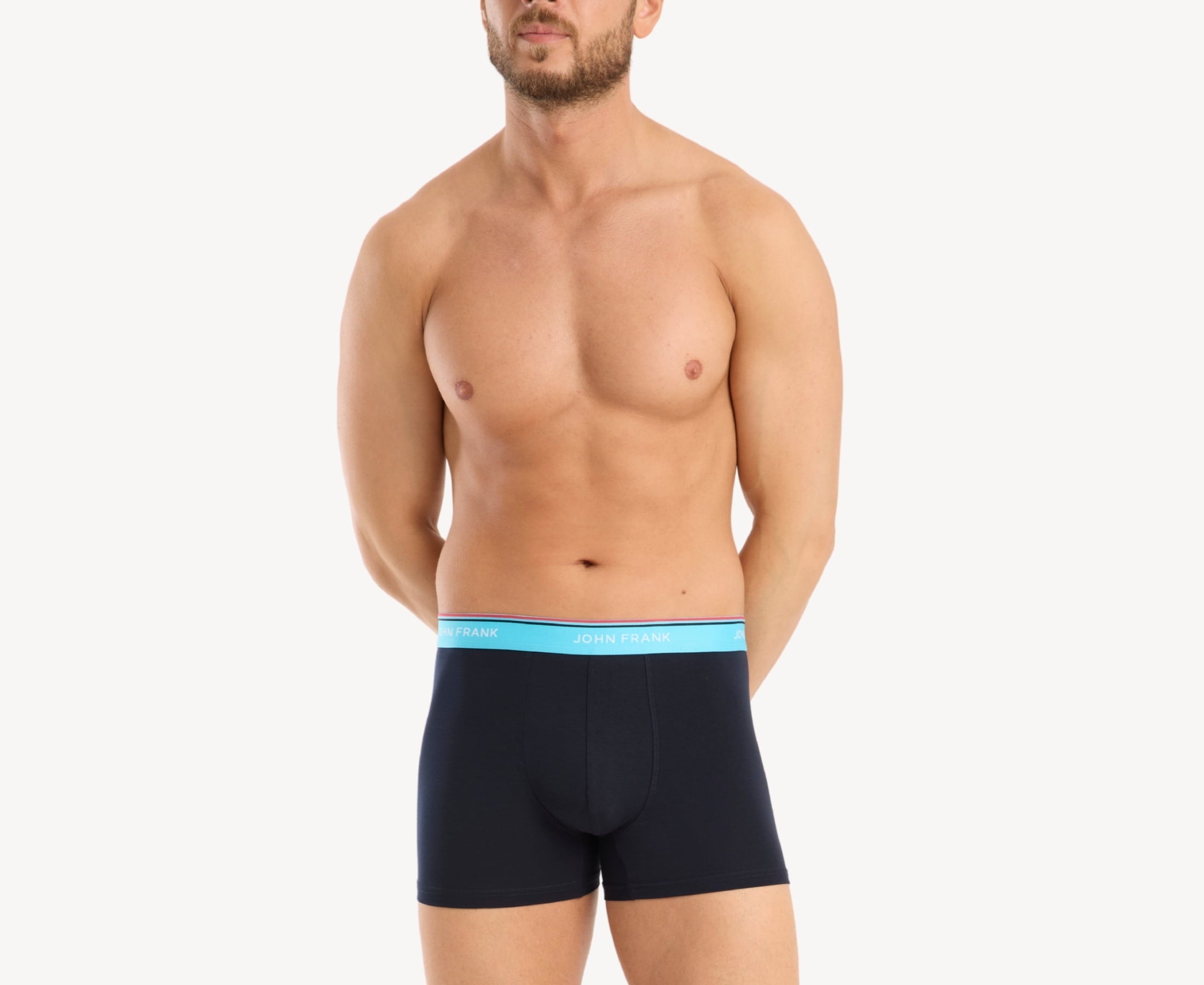 Front view of model wearing men’s 95% cotton boxer brief in midnight blue with turquoise striped waistband and soft stretch