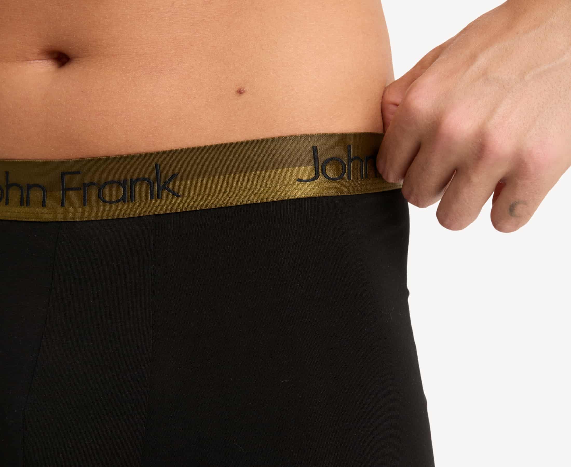 Waistband detail of men’s 95% cotton boxer brief in black with yellow-metal shiny waistband, invisible seams and soft stretch