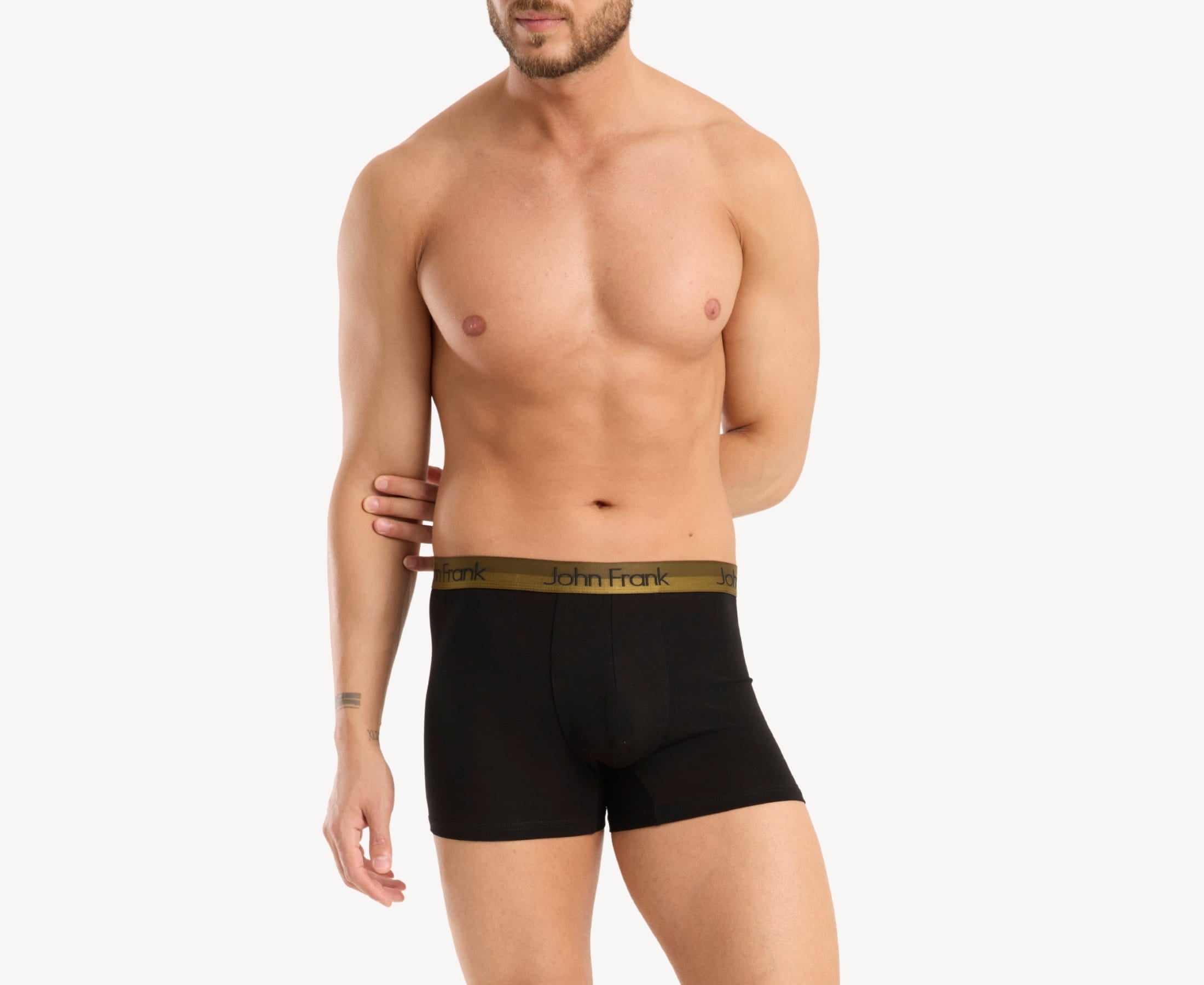 Front view of model wearing men’s 95% cotton boxer brief in black with yellow-metal shiny waistband, invisible seams and soft stretch