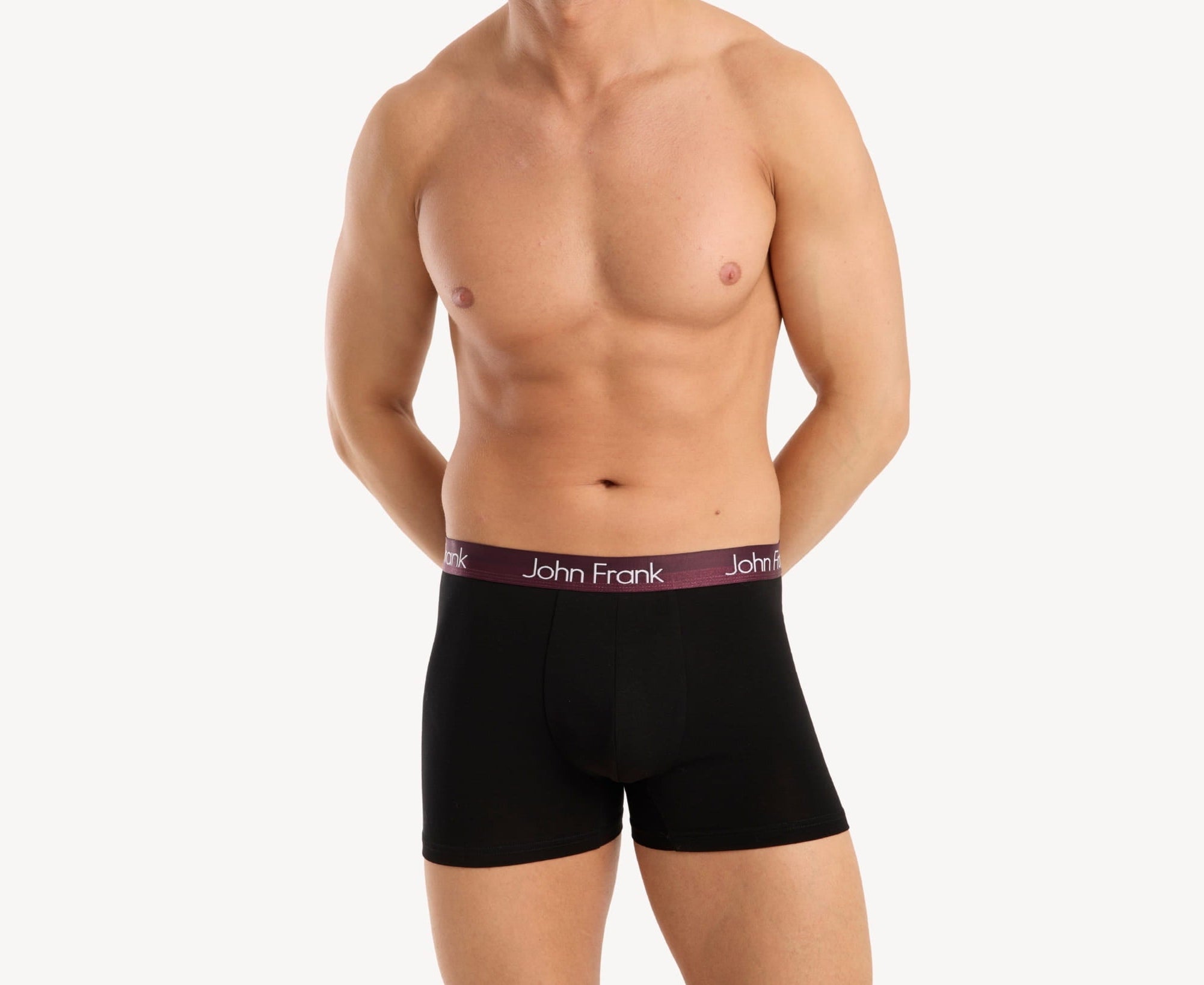 Front view of model wearing men’s 95% cotton boxer brief in black with burgundy shiny waistband, invisible seams and soft stretch