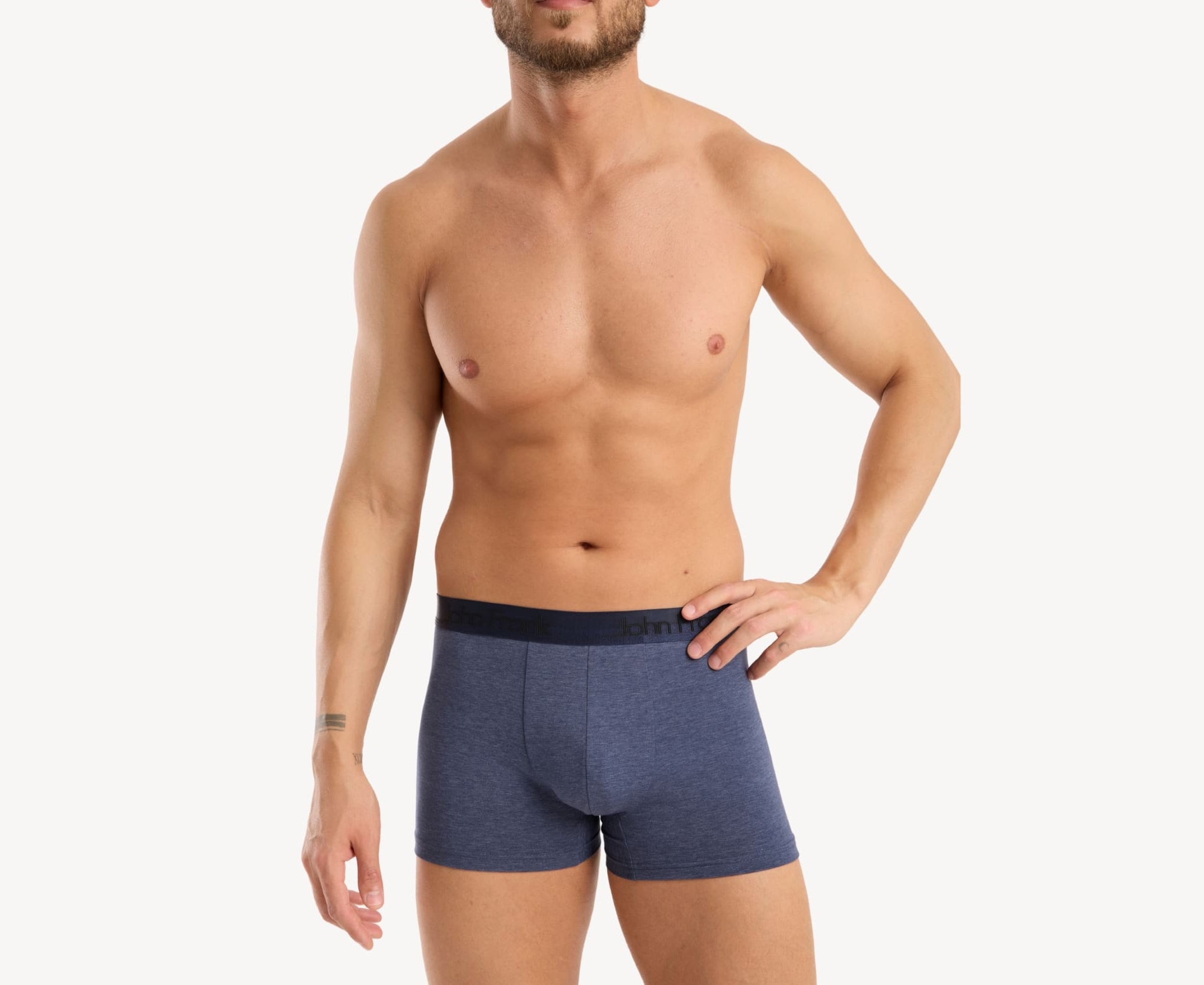 Front view of model wearing men’s 95% cotton boxer brief in slate blue with dark blue shiny waistband, invisible seams and soft stretch
