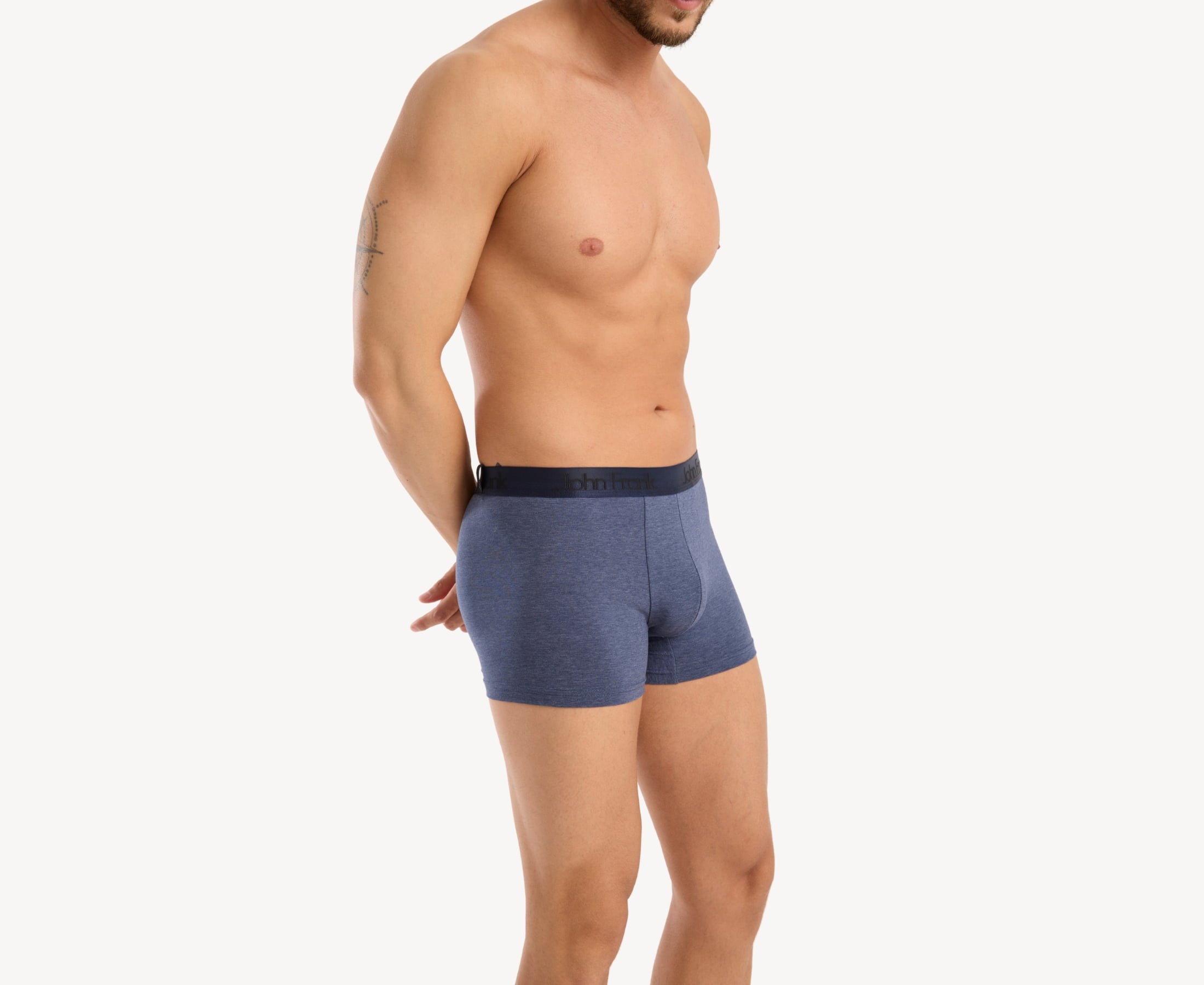 Side view of model wearing men’s 95% cotton boxer brief in slate blue with dark blue shiny waistband, contoured pouch, and tailored leg cut