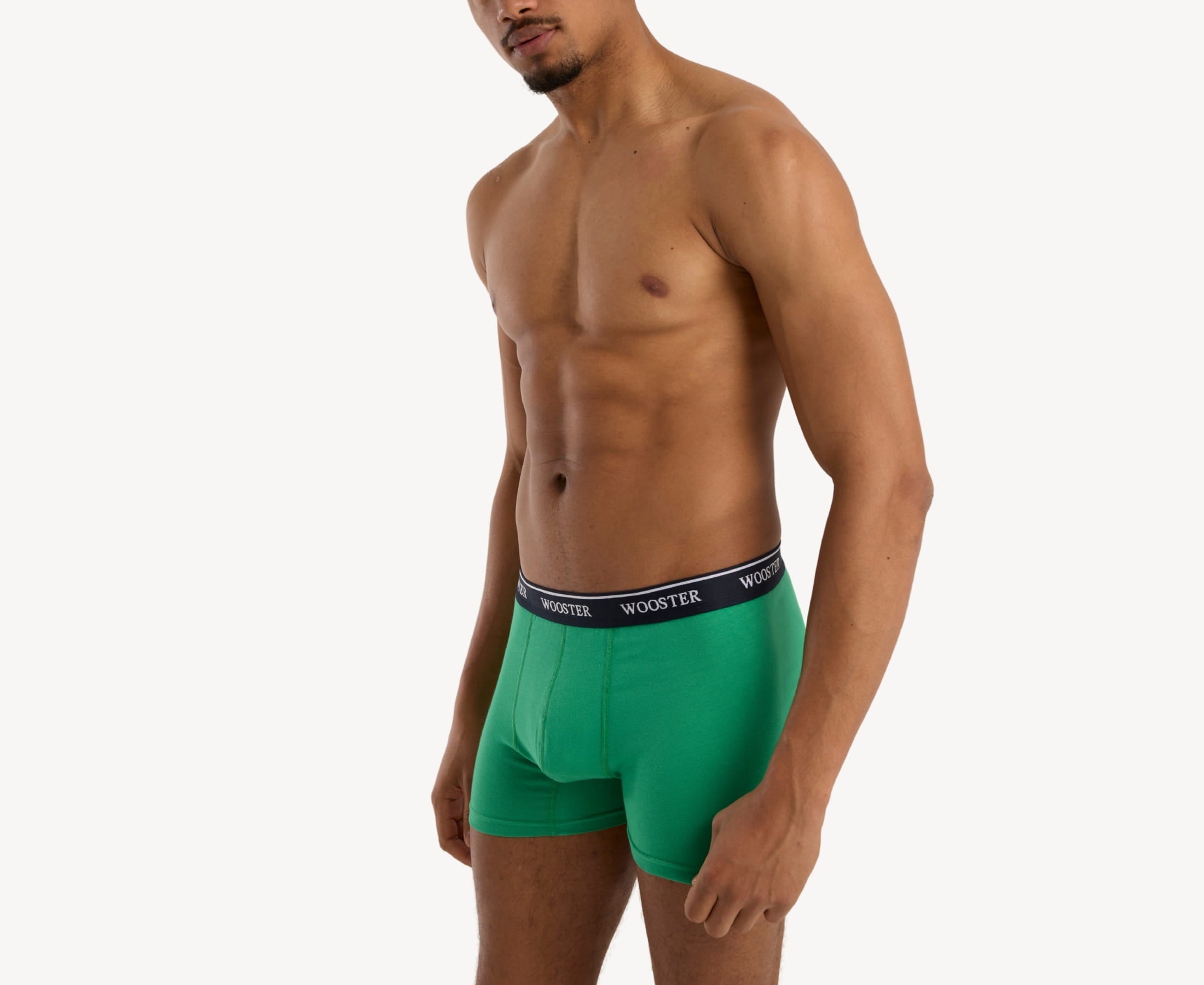 Side view of model wearing men’s 95% cotton boxer brief in meadow green showing contoured pouch and relaxed fit