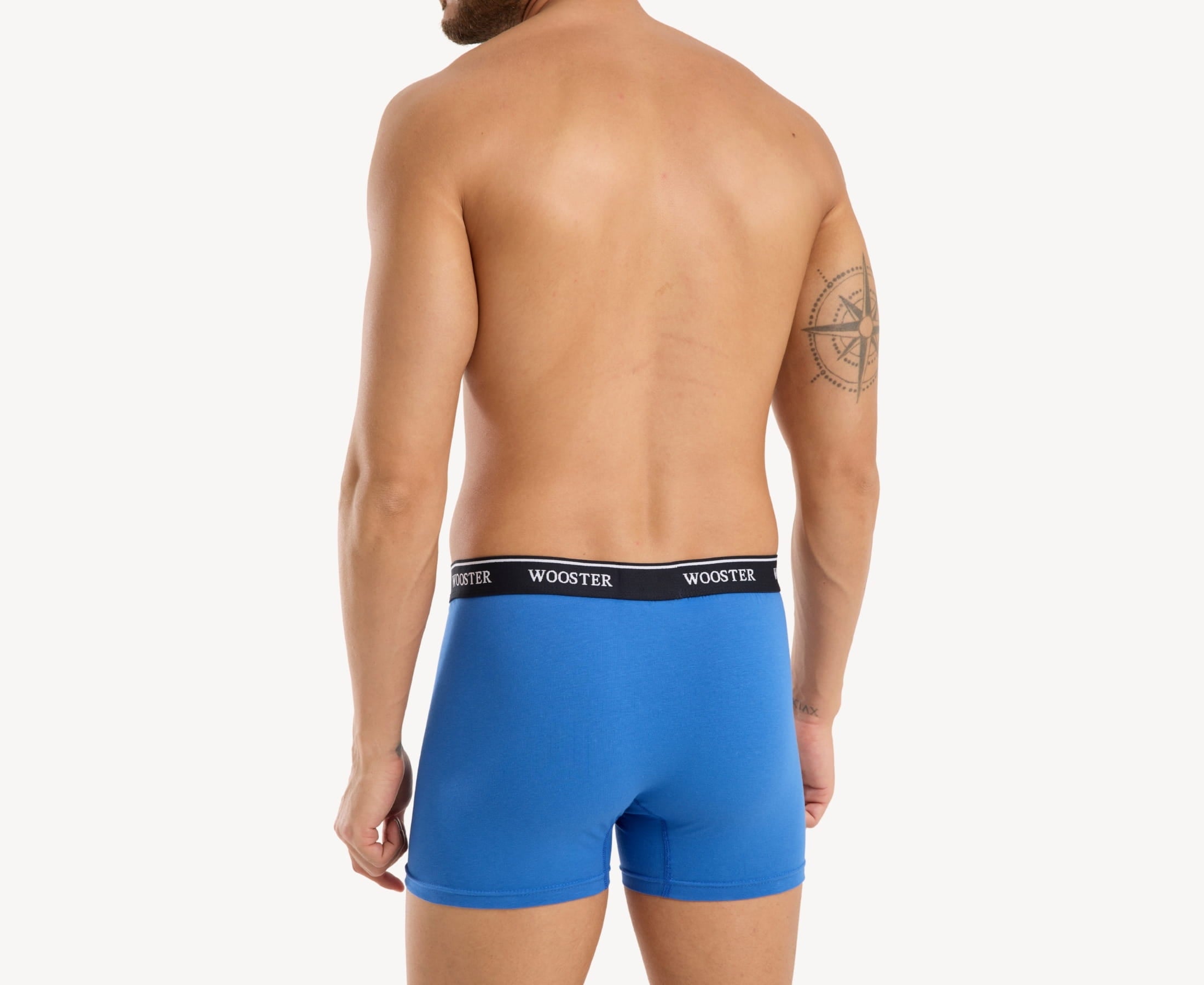 Back view of model wearing men’s 95% cotton boxer brief in sky blue with relaxed fit, vibrant color, and smooth rear panel
