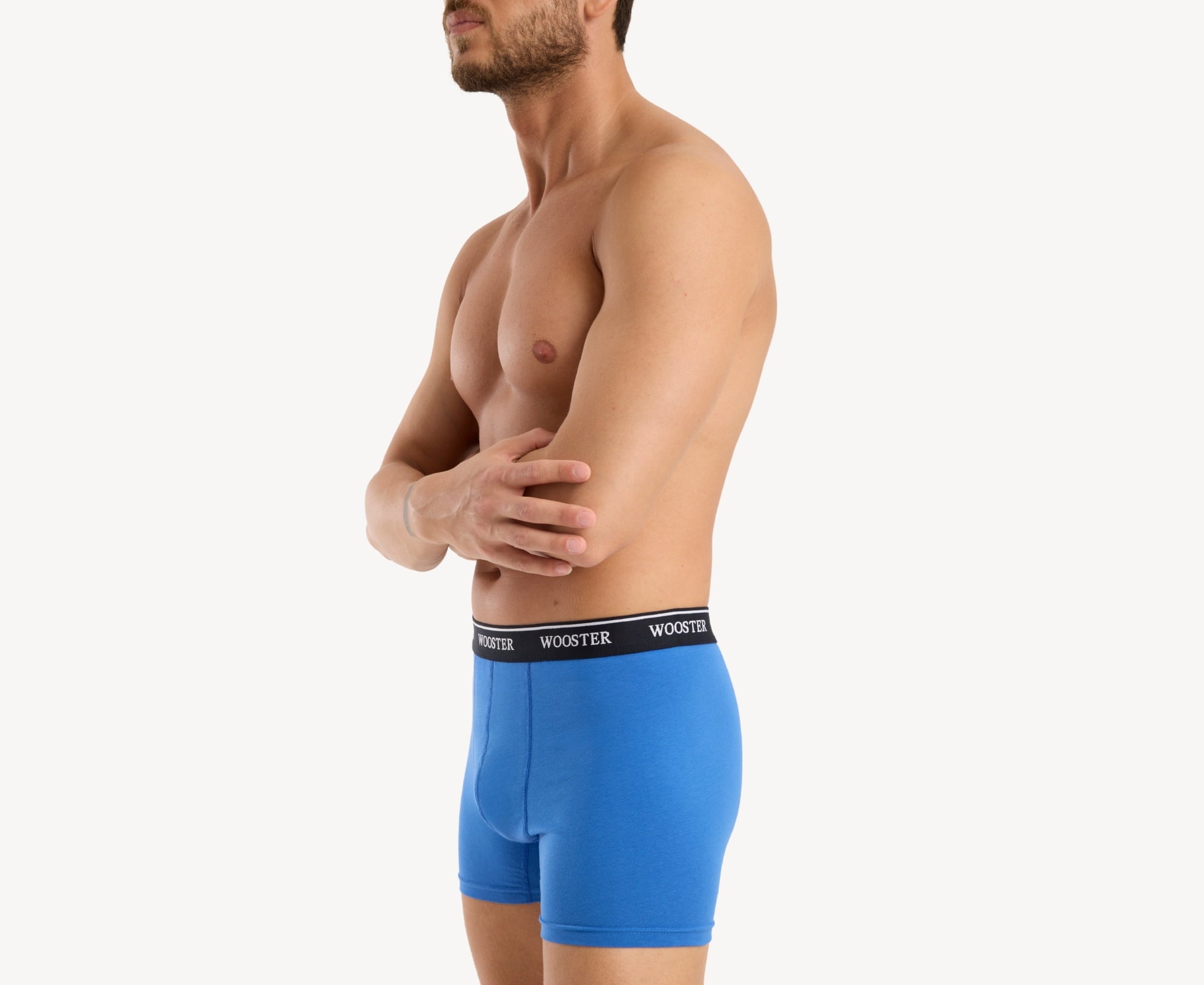 Side view of model wearing men’s 95% cotton boxer brief in sky blue showing contoured pouch and relaxed fit