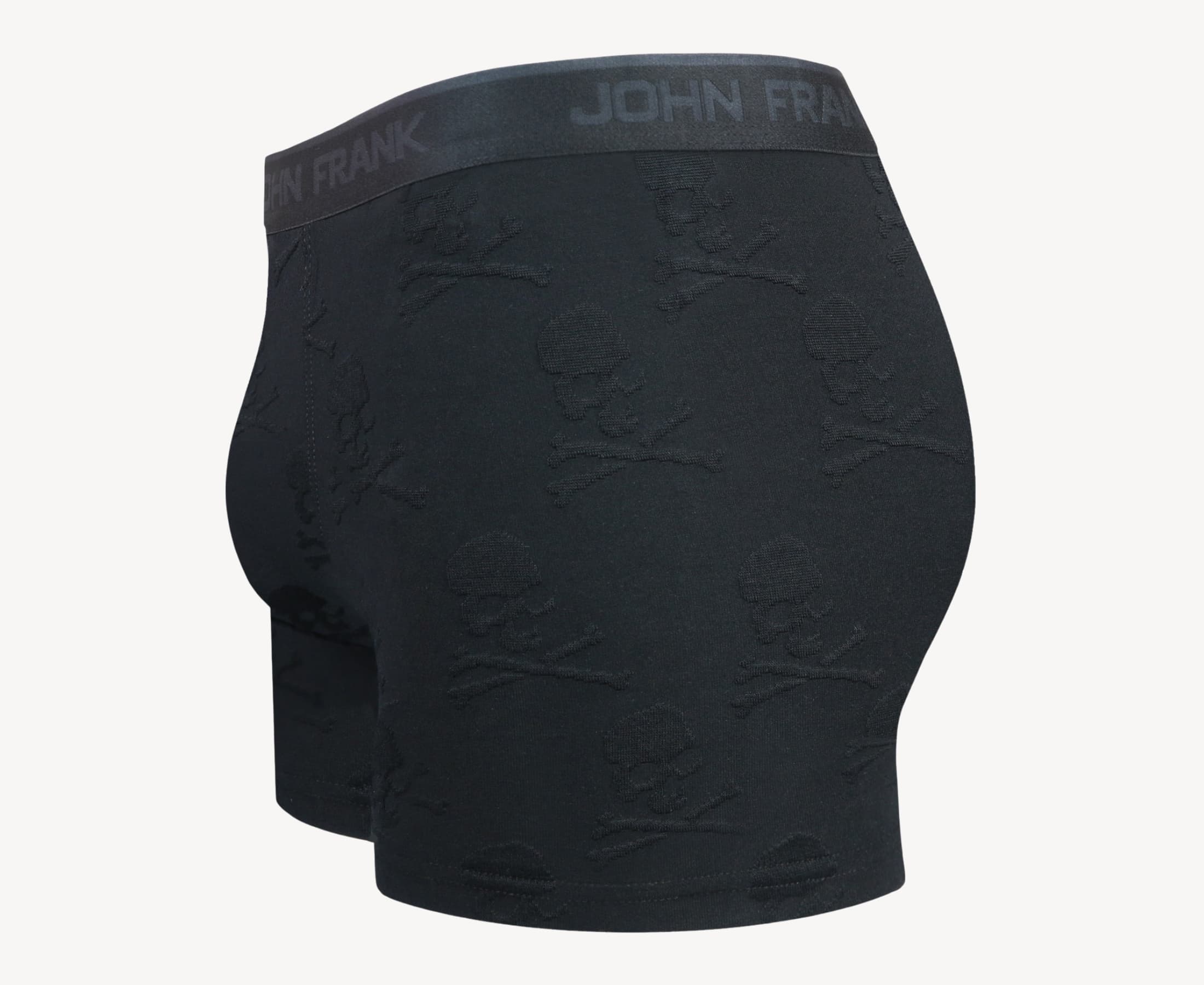 Side view of men’s 95% micromodal boxer brief in black with jacquard skull and cross bones pattern, showcasing contoured pouch, and tailored leg cut