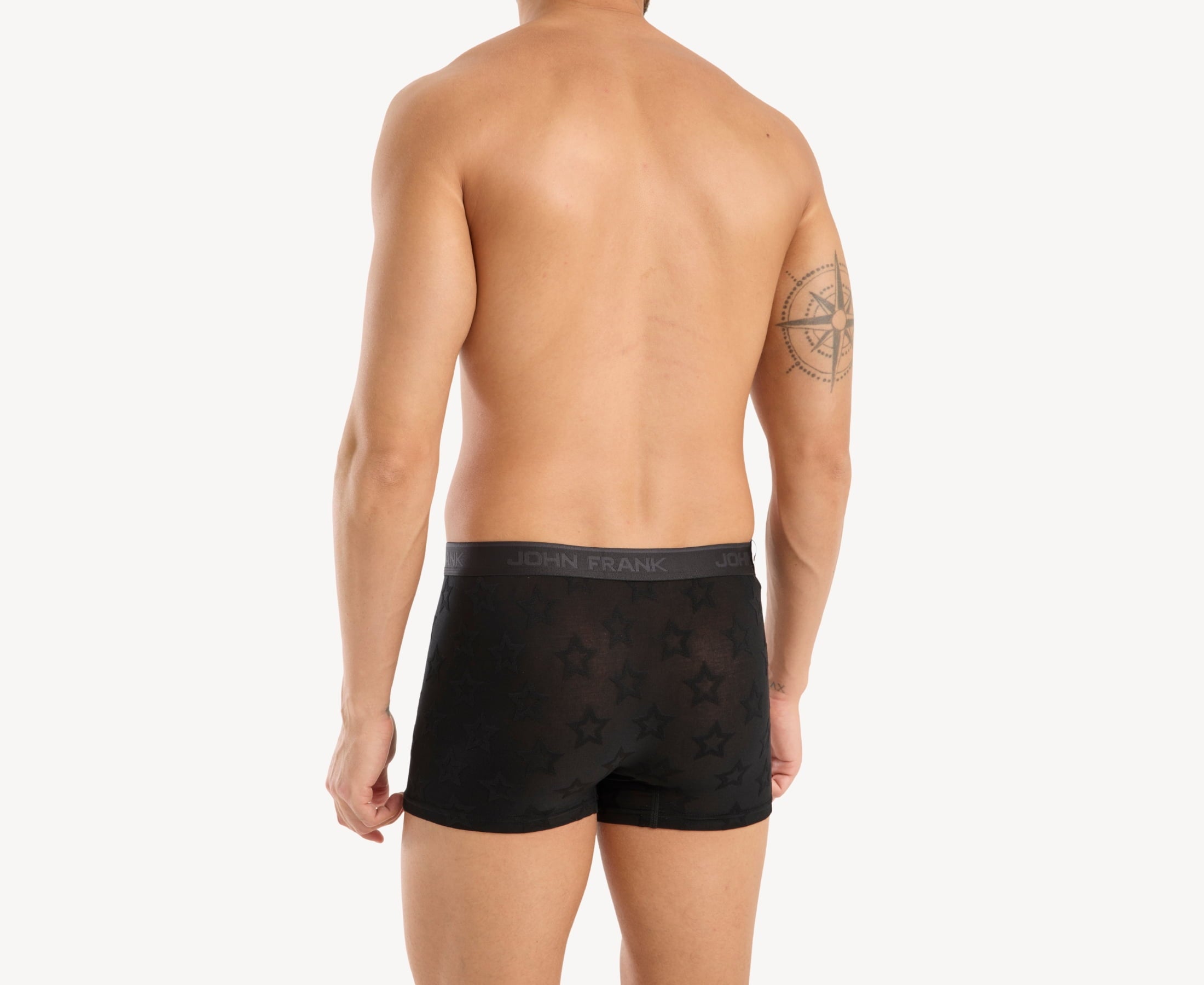 Back view of model wearing men’s 95% micromodal boxer brief in black with jacquard stars pattern, showcasing smooth waistband and rear detail