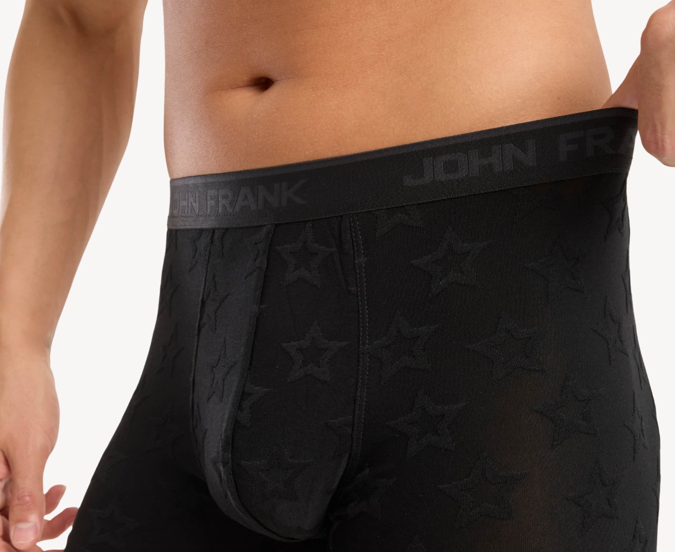 Close-up view of men’s 95% micromodal boxer brief in black with jacquard stars pattern, showcasing the smooth no-roll waistband