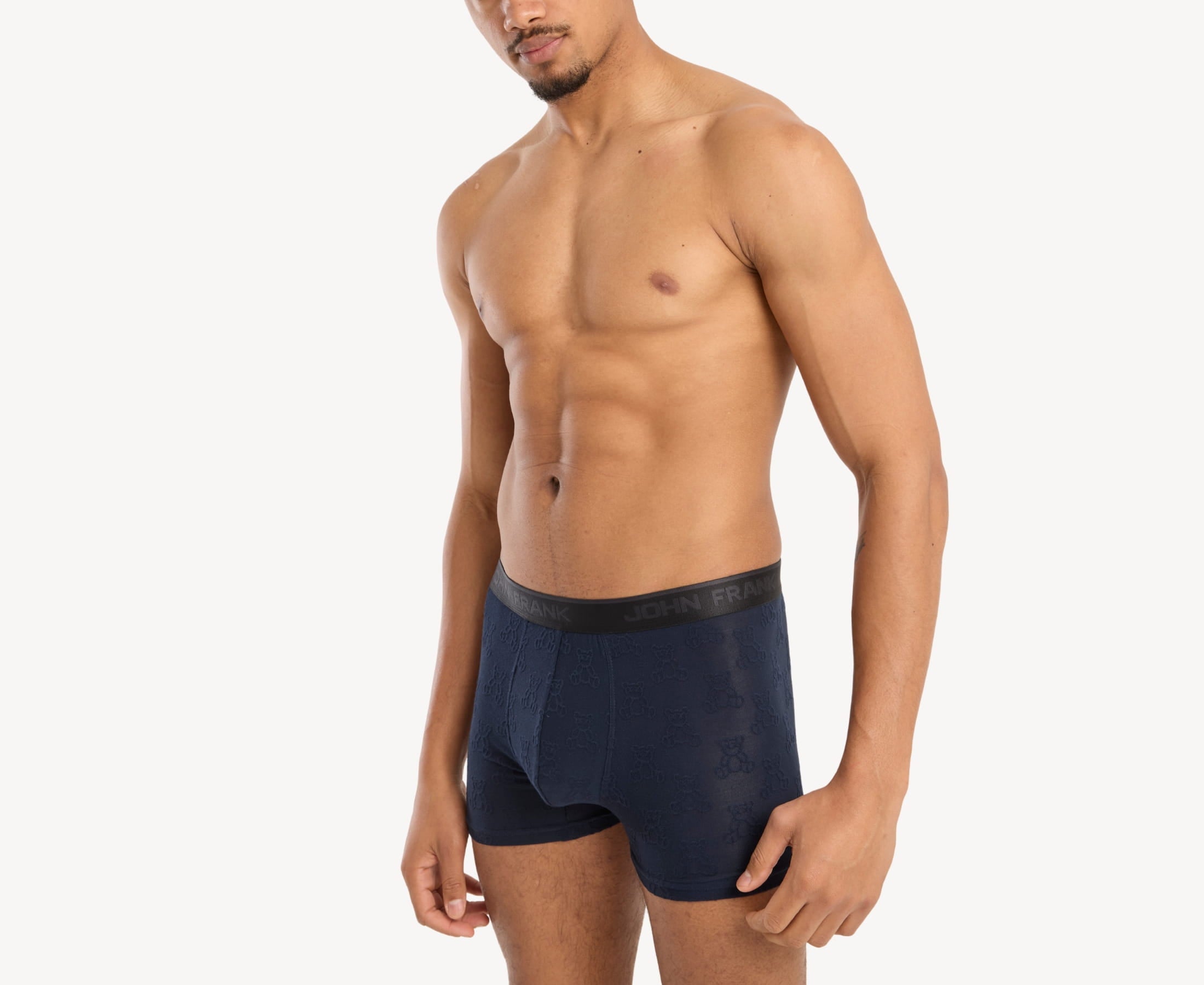 Side view of model wearing men’s 95% micromodal boxer brief in navy with jacquard teddy bears pattern, showcasing contoured pouch, and tailored leg cut