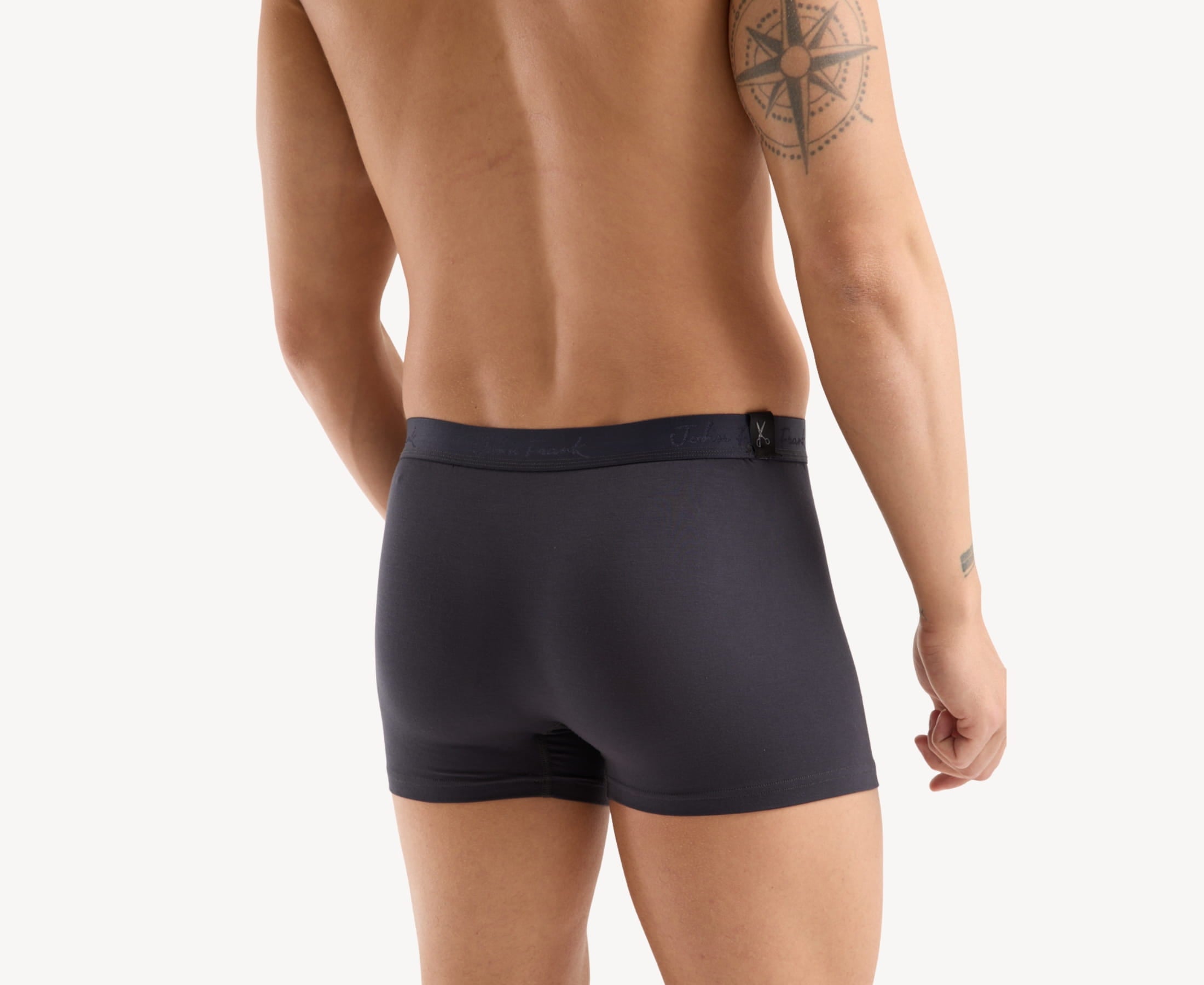 Back view of model wearing men’s 95% micromodal boxer brief in anthracite with tonal waistband featuring subtle sheen and clean rear detail