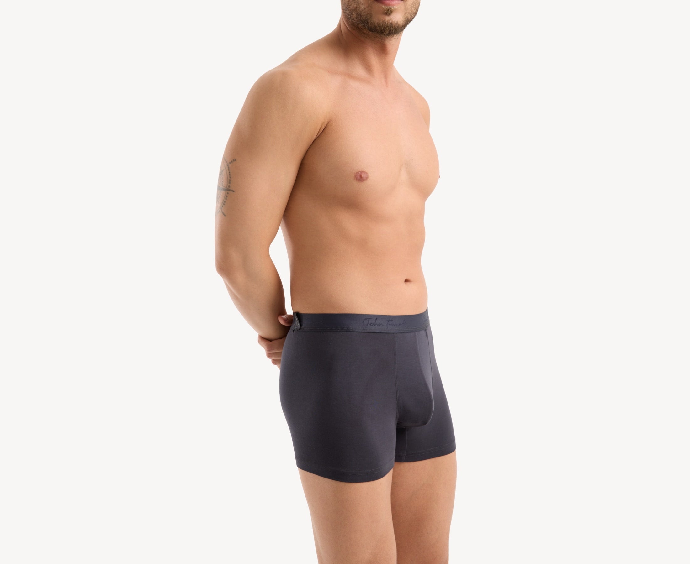 Side view of model wearing men’s 95% micromodal boxer brief in anthracite with contoured pouch and tailored leg cut