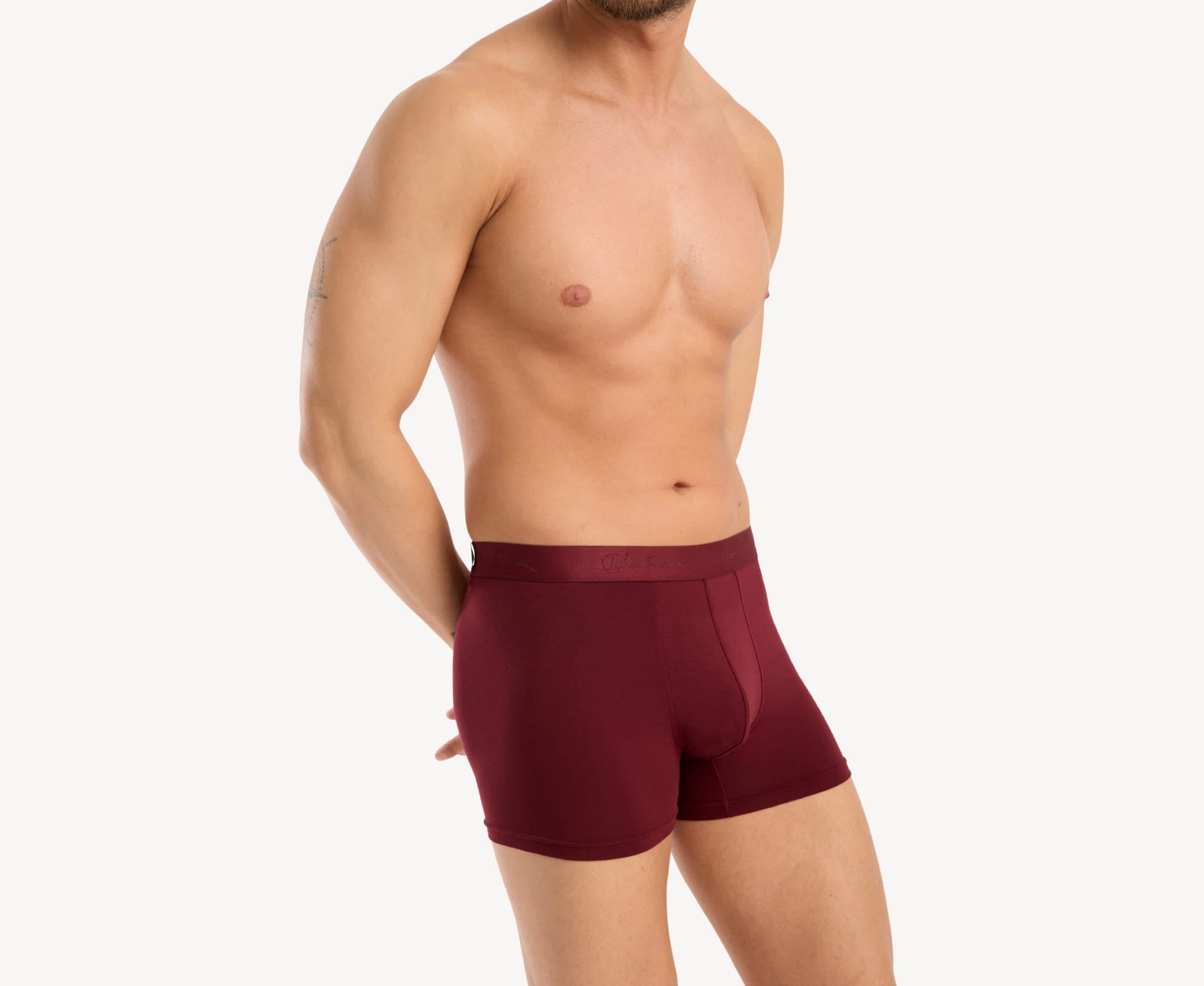 Side view of model wearing men’s 95% micromodal boxer brief in bordeaux with contoured pouch and tailored leg cut