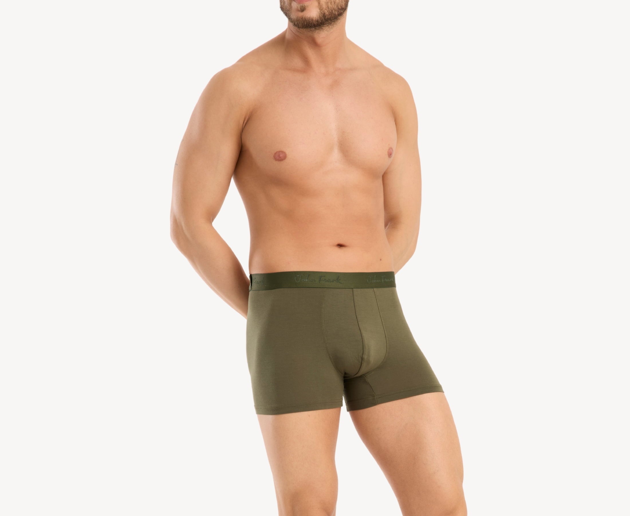 Side view of model wearing men’s 95% micromodal boxer brief in olive with contoured pouch and tailored leg cut