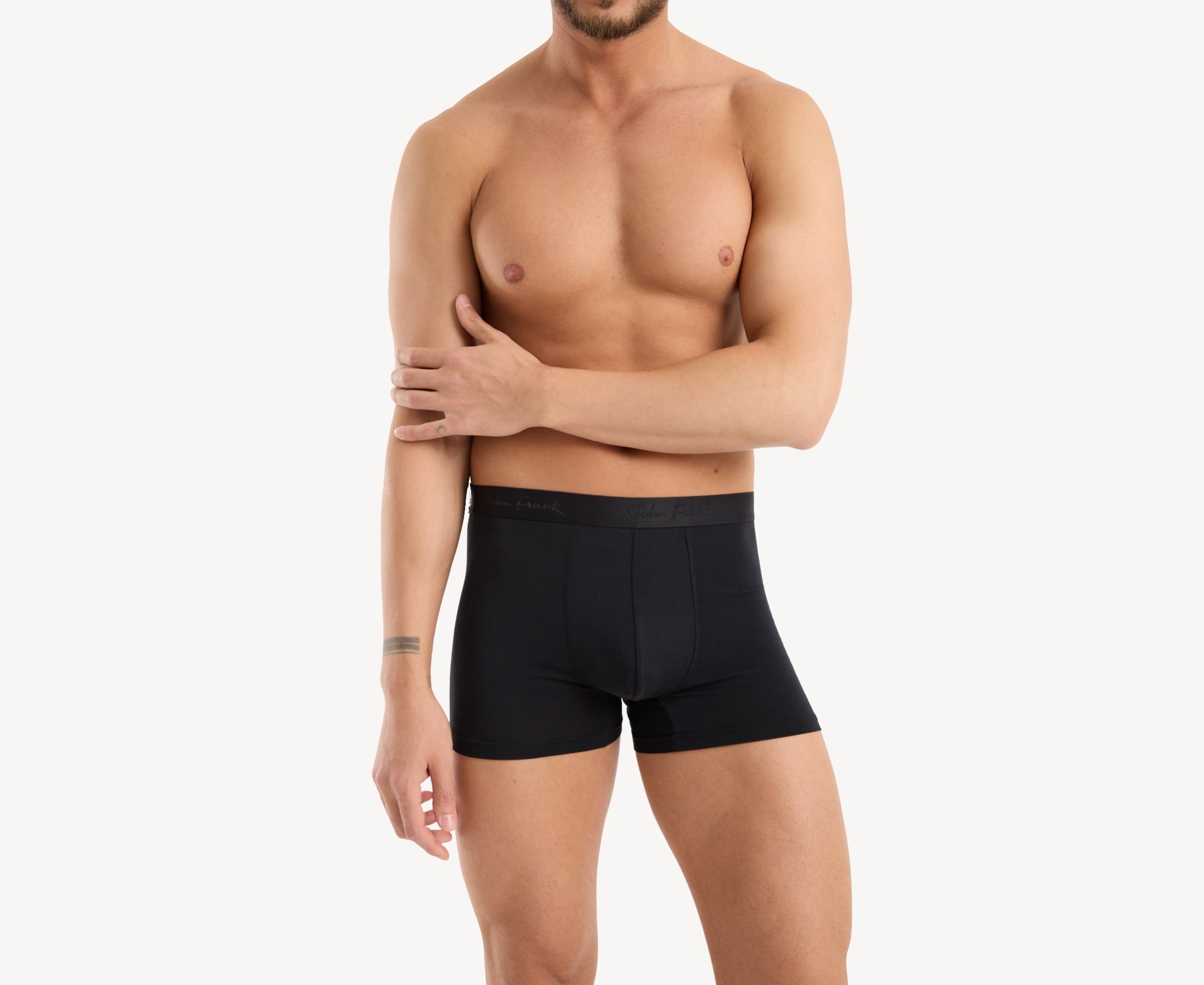 Front view of model wearing men’s 95% micromodal boxer brief in pitch black with tonal waistband featuring subtle sheen, and soft stretch