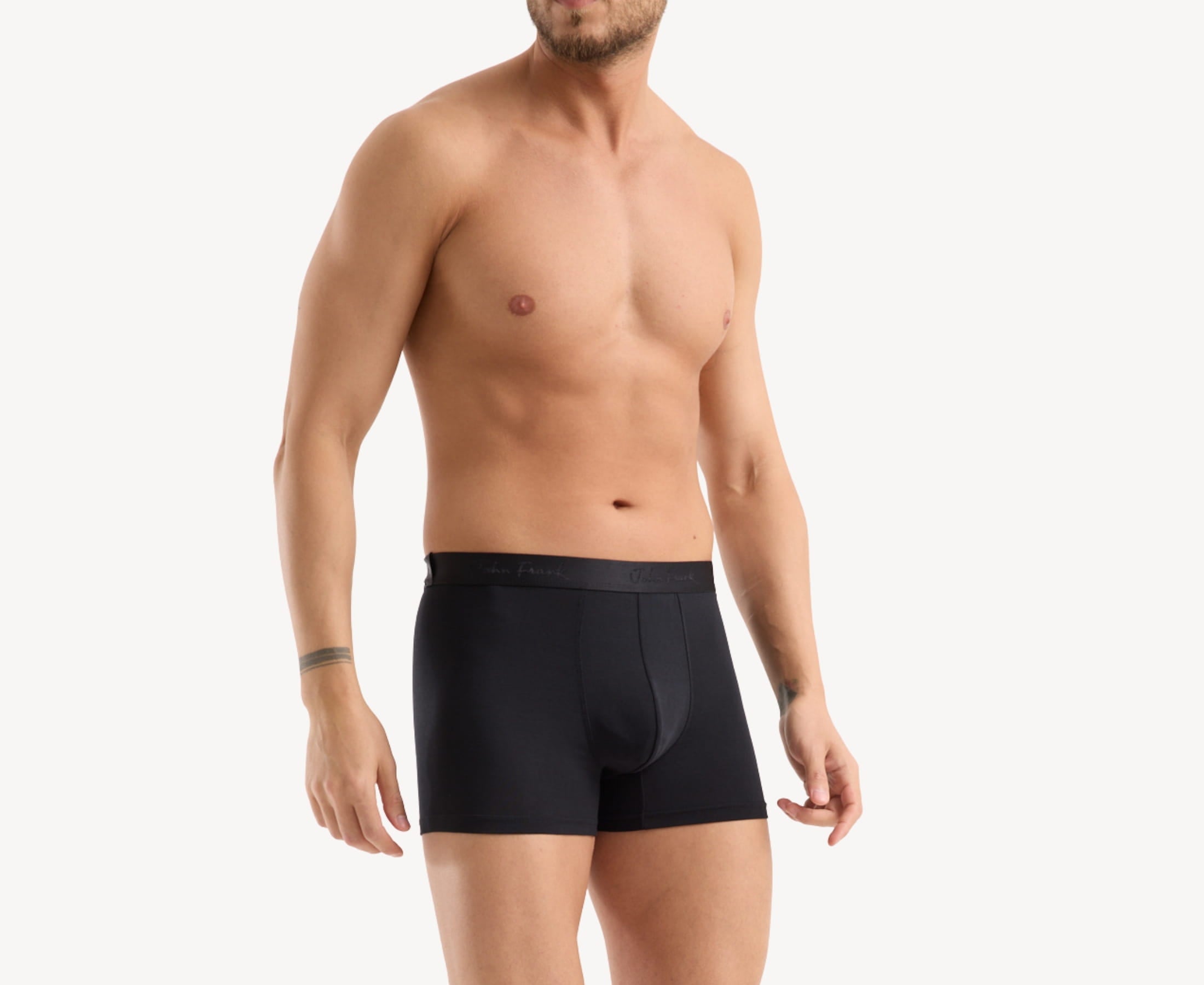 Side view of model wearing men’s 95% micromodal boxer brief in pitch black with contoured pouch and tailored leg cut