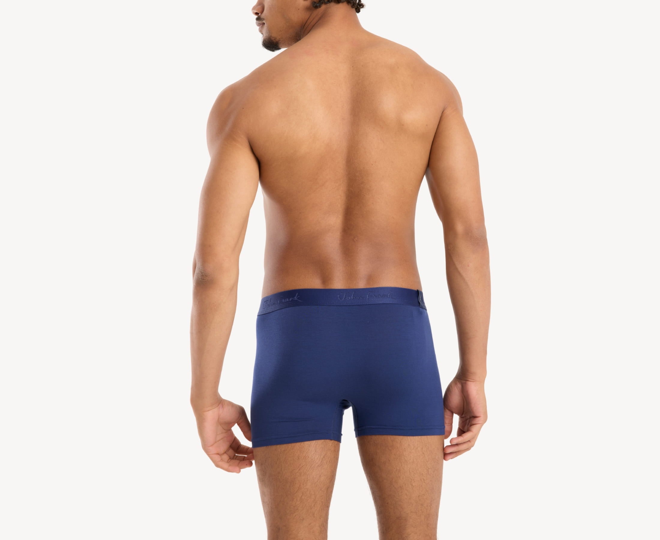 Back view of model wearing men’s 95% micromodal boxer brief in royal blue with tonal waistband featuring subtle sheen and clean rear detail