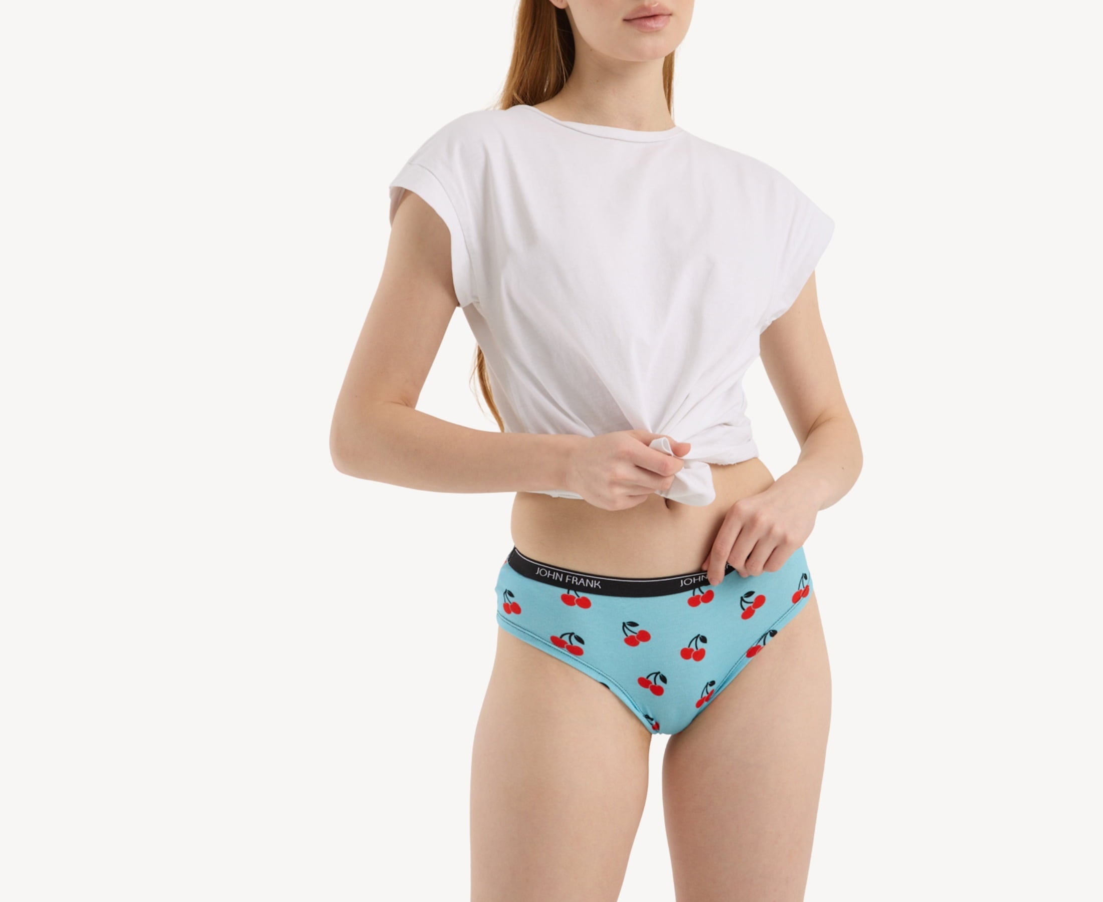 Front view of model wearing women’s 95% premium cotton hipster in sky blue with cherry print, showcasing mid-rise cut and smooth waistband.